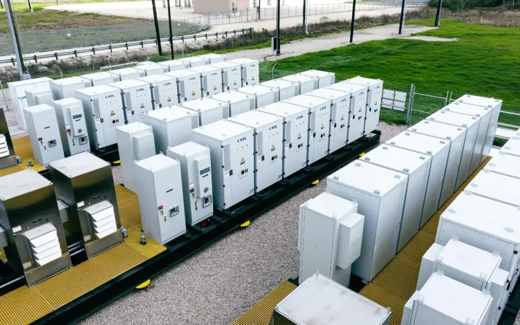 Rows of white battery storage cabinets at an energy storage facility